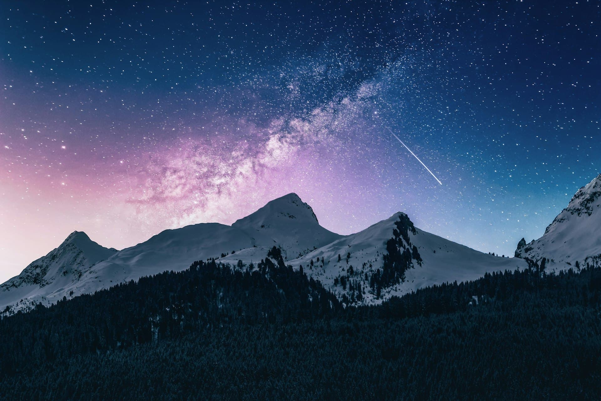 Starry night sky with constellation patterns over mountains