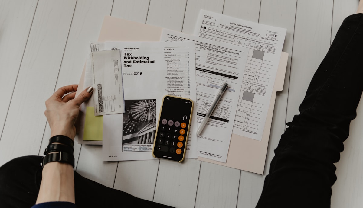 Financial charts on a screen next to a notebook — used for Financial and Private Wealth.